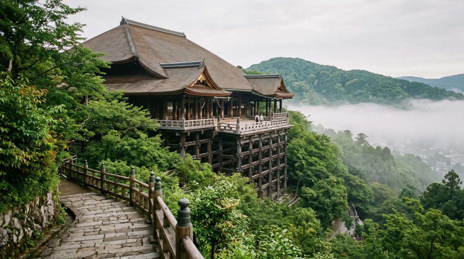 The wooden stage of Kiyomizu-dera on its pillars above the wooded hillside at first light, Kyoto Japan
