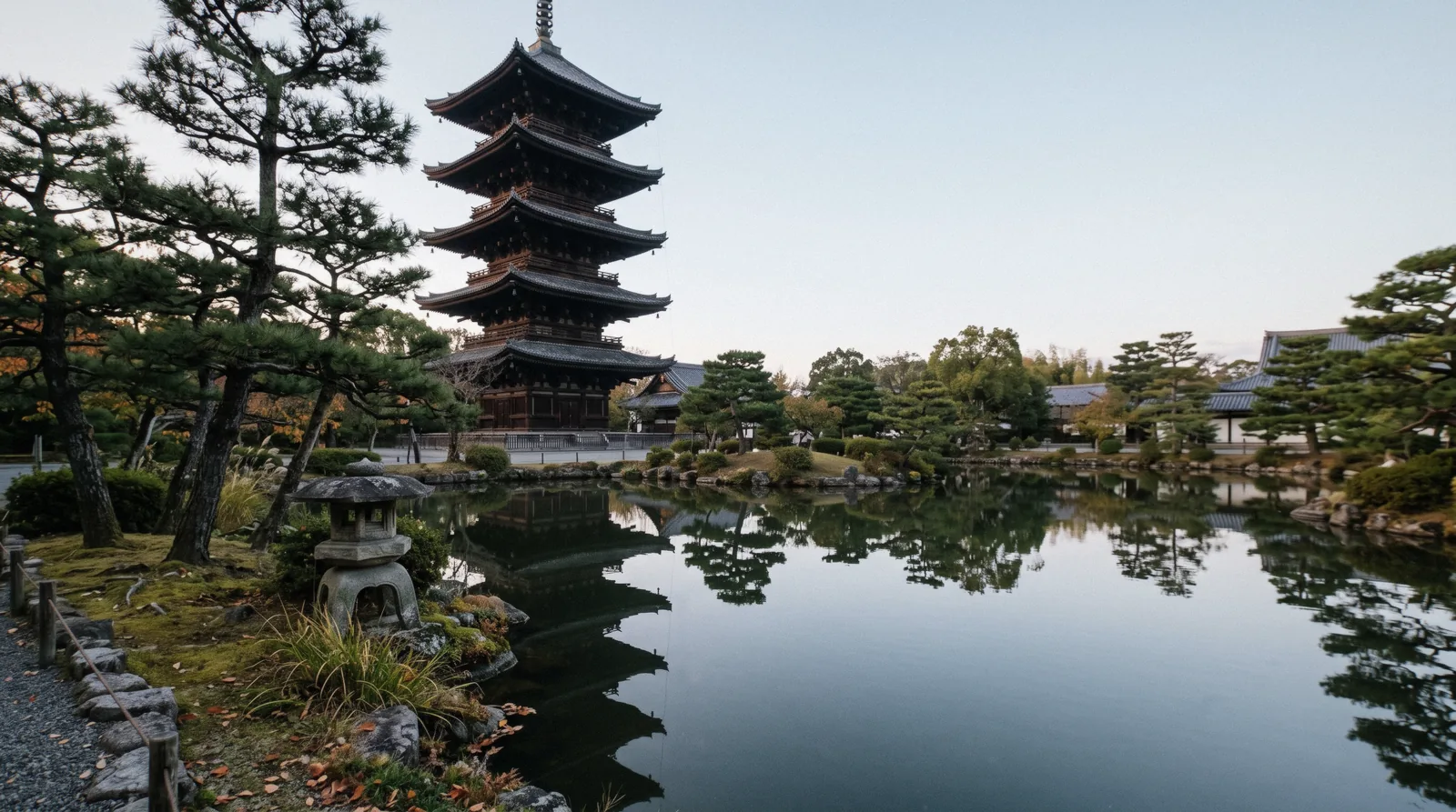 The five-storey pagoda of To-ji rising above the pond and pines in the early morning, Kyoto Japan