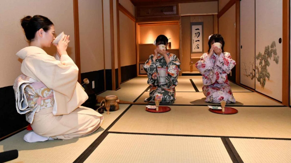 Guests in kimono preparing matcha at a tea ceremony in Gion, Kyoto Japan
