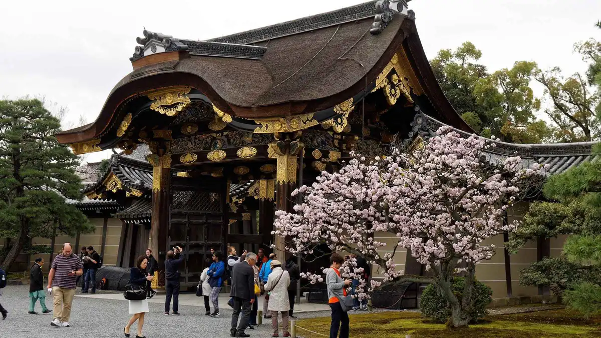 Gravel forecourt and gate of the Kyoto Imperial Palace on a guided walking tour, Kyoto Japan
