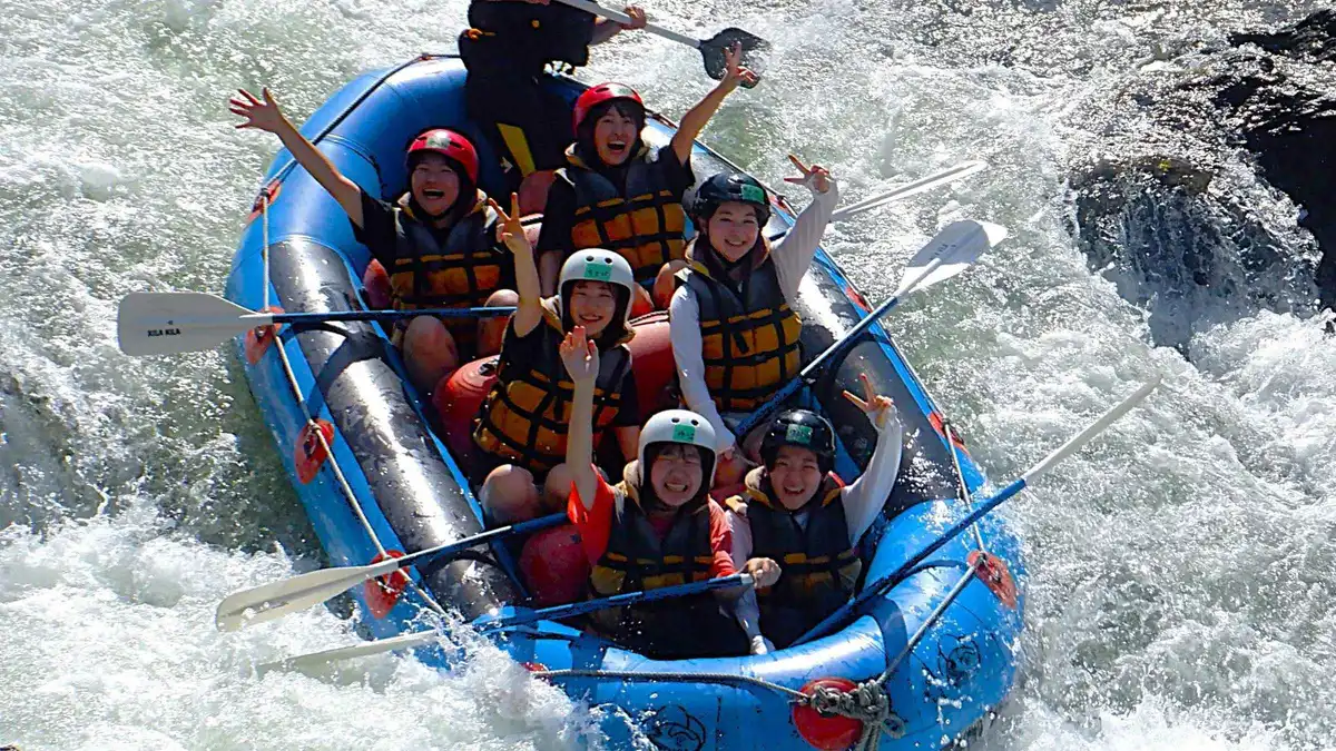 Raft running a rapid on the Hozugawa River gorge near Arashiyama, Kyoto Japan