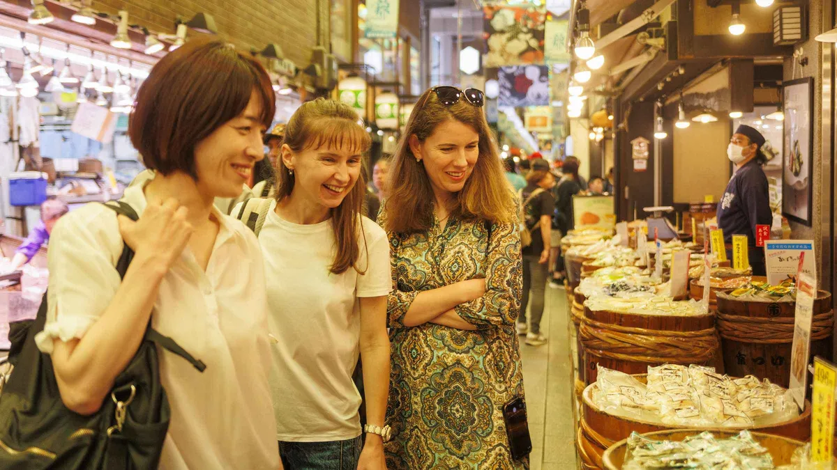 Grilled wagyu skewers and yuba at a Nishiki Market stall on a food tour, Kyoto Japan