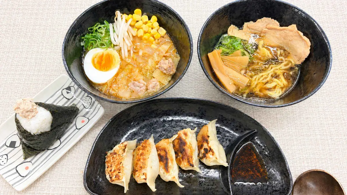 Students folding gyoza at a ramen cooking class in Kyoto, Kyoto Japan