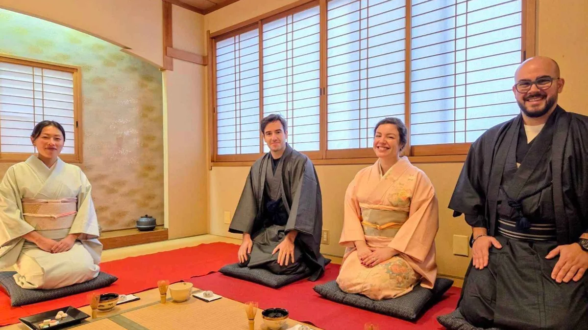 Guest whisking matcha with a bamboo chasen at a small-group Kyoto tea ceremony, Kyoto Japan