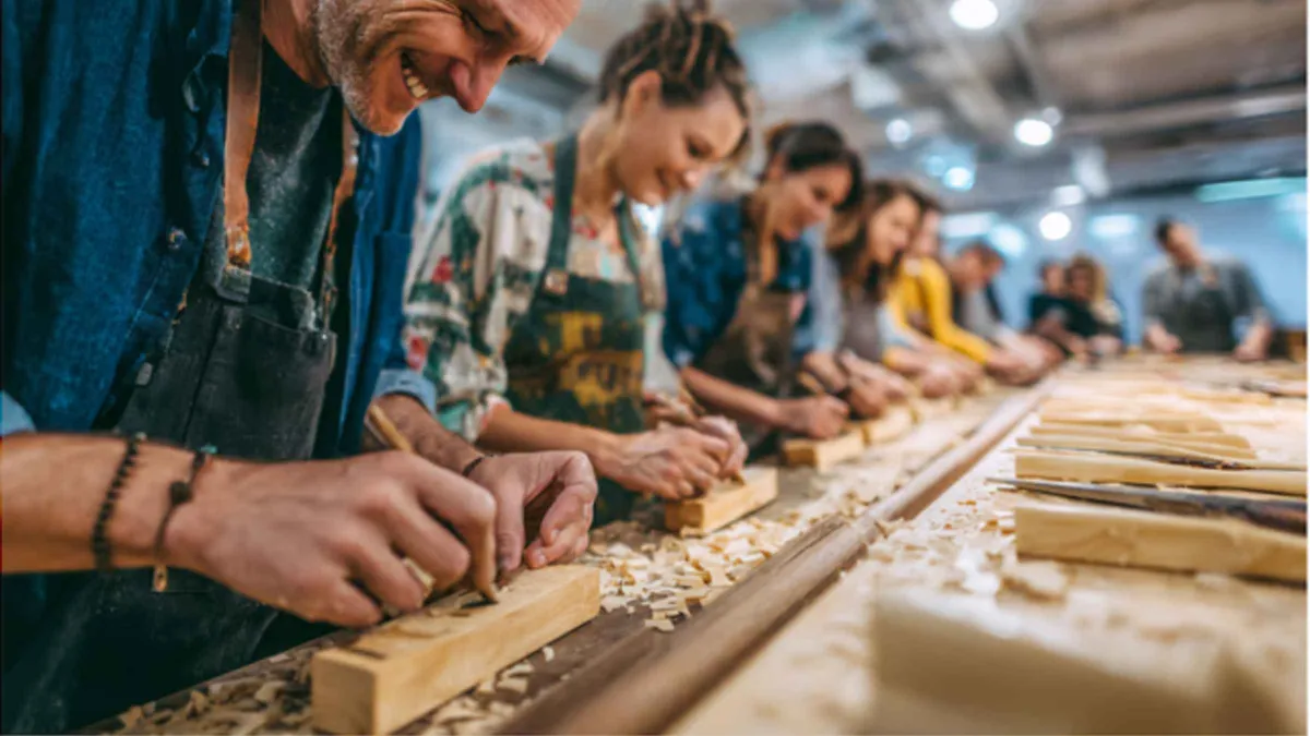 Hands shaping wooden chopsticks at a craft workshop in Gion, Kyoto Japan