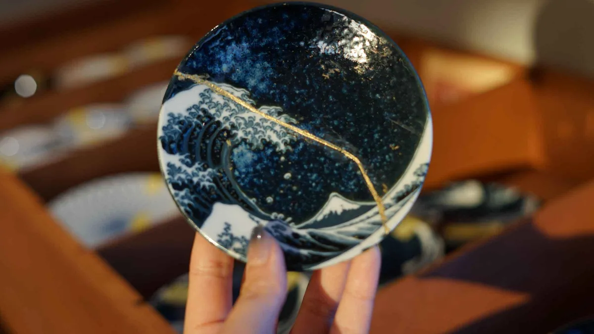 Ceramic bowl repaired with gold seams at a kintsugi workshop in Gion, Kyoto Japan