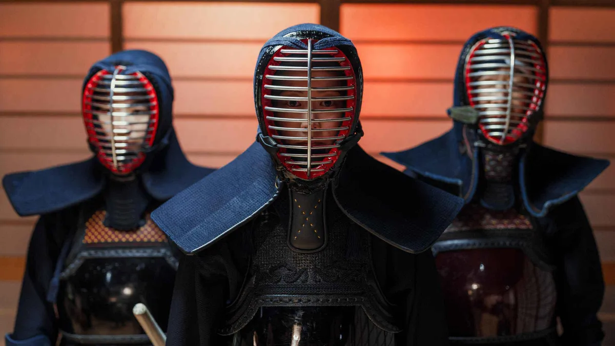 Participants in kendo armour practising sword cuts at a Kyoto dojo, Kyoto Japan