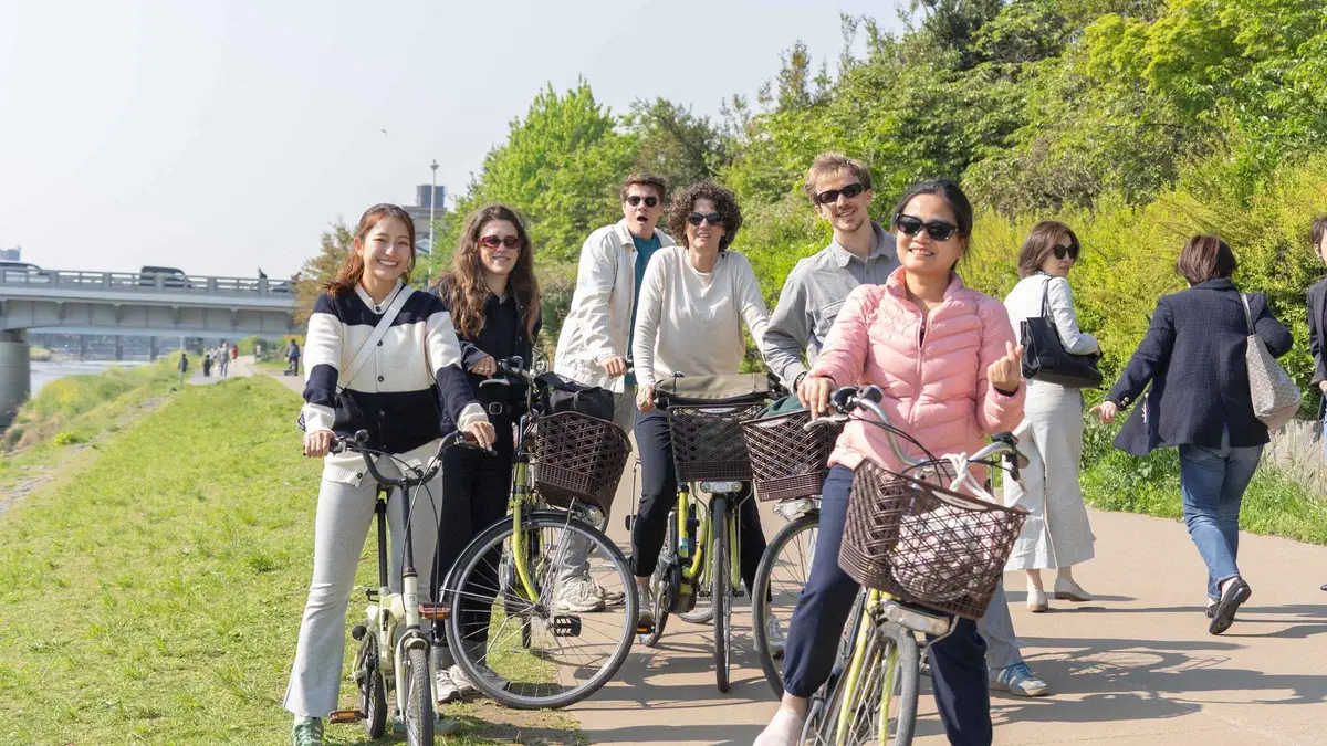 E-bike riders on a quiet canal street away from the crowds in Kyoto, Kyoto Japan