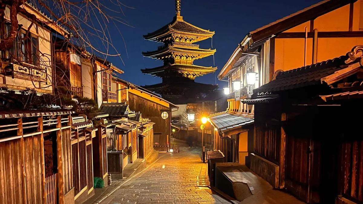 Softly lit stone lane in Gion after dark on a night walking tour, Kyoto Japan