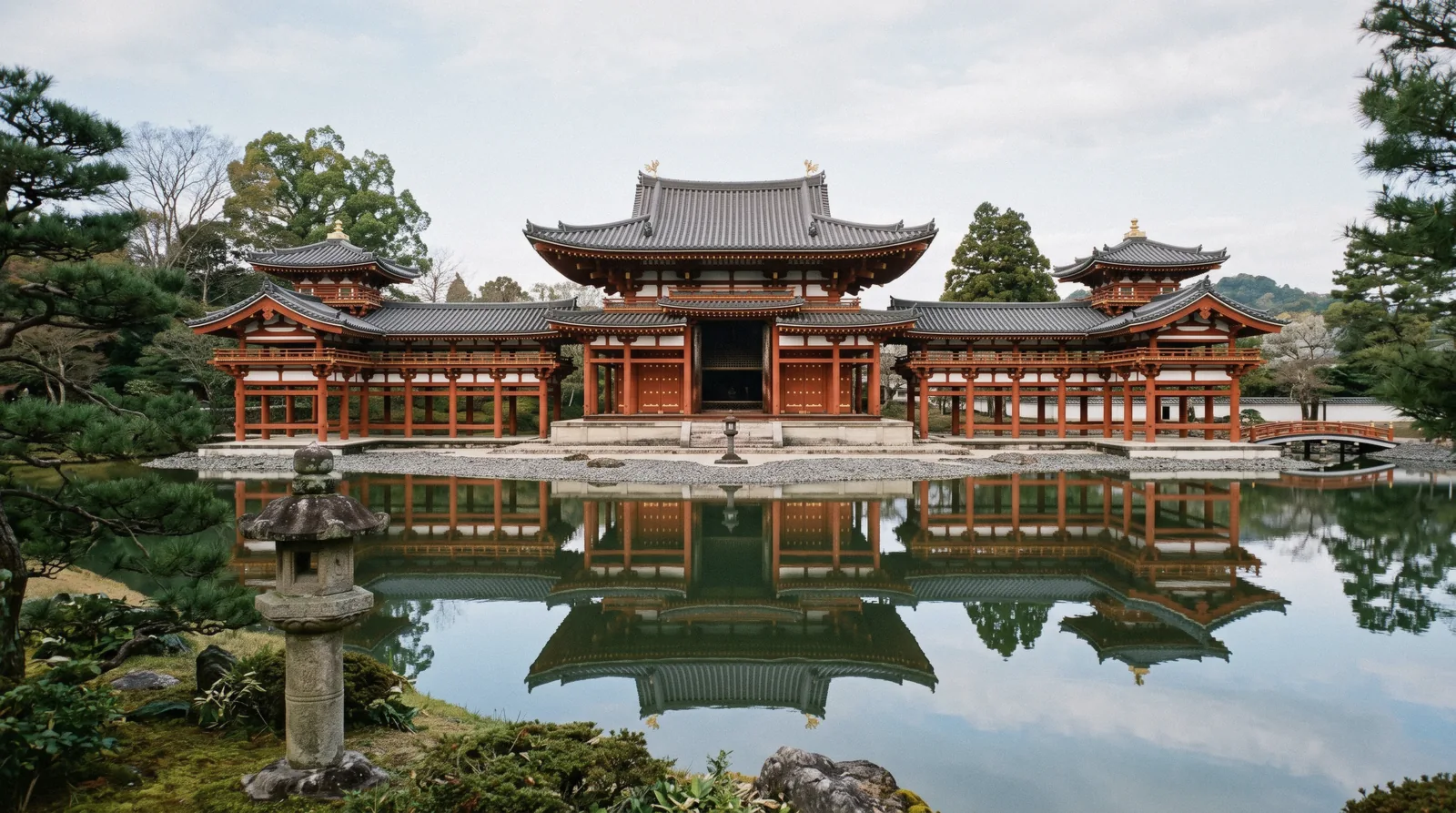 The Phoenix Hall of Byodo-in reflected in its pond in morning light, Uji Japan